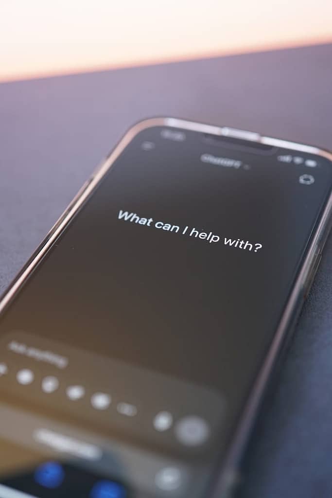 Phone screen asks: "what can i help with? " waiting for somebody to try a free ai tarot reading.