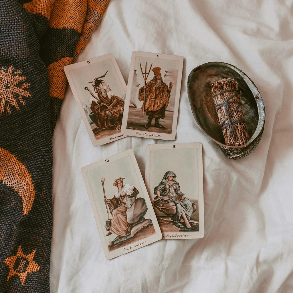 tarot cards on a sheet with a shell