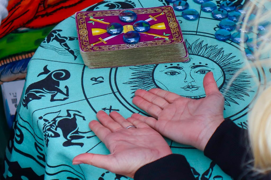 person holding hands out offering ethical tarot readings