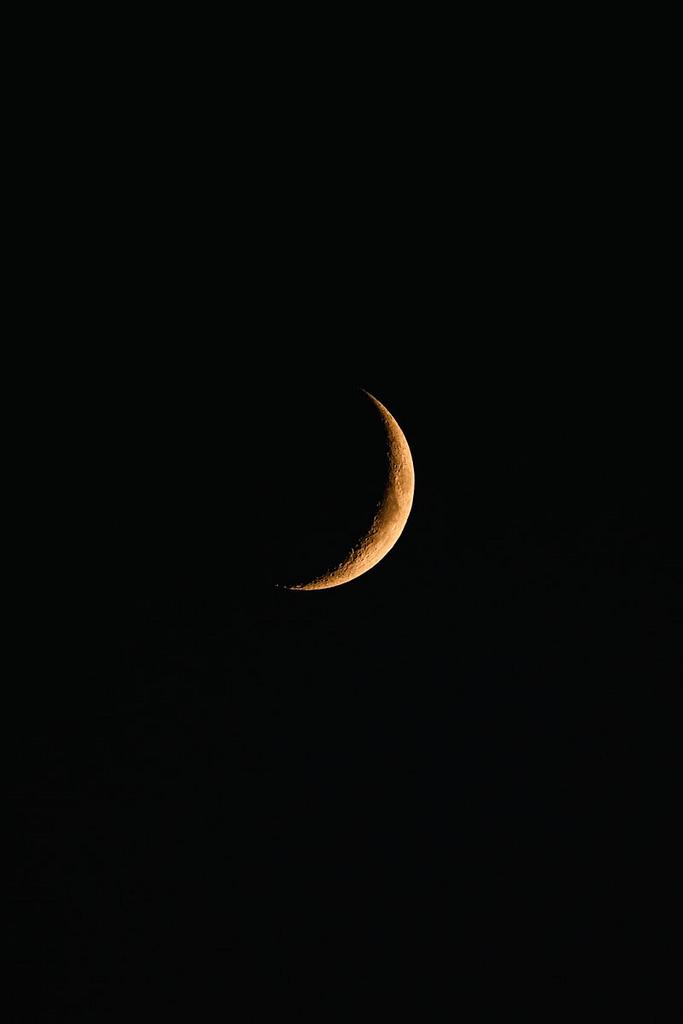 a waxing crescent moon in the sky