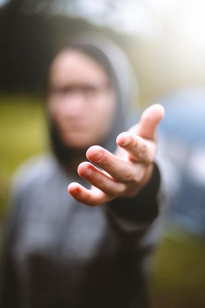 a blurry image of a person holding out their hand