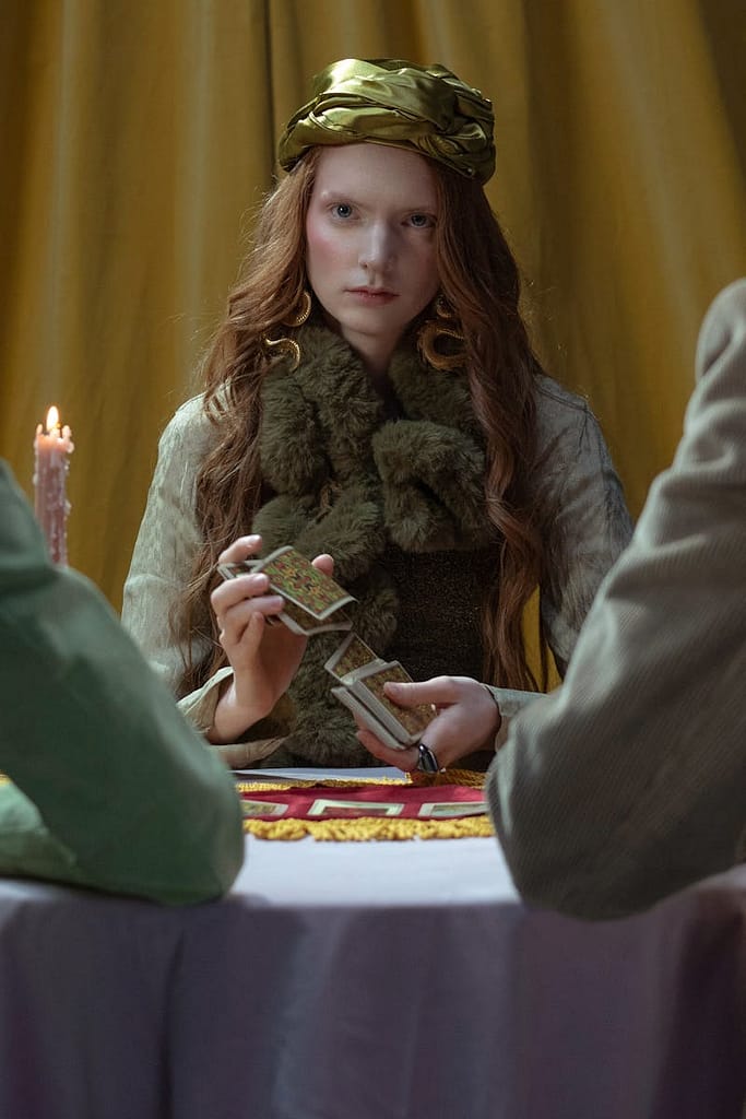 A woman conducts an online tarot reading, adding a mystical touch to the room's ambiance.