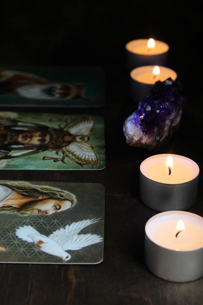 Tarot cards laid out with candles during a real tarot reading session