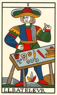 The Magician card (Le Bateleur) from the Tarot de Marseille, featuring a figure in a colourful medieval outfit standing behind a table with symbolic objects like cups, dice, and knives, drawn in a woodcut-style illustration.