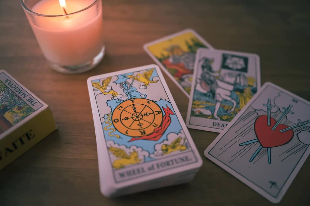 Set of tarot cards on a table with a candle
