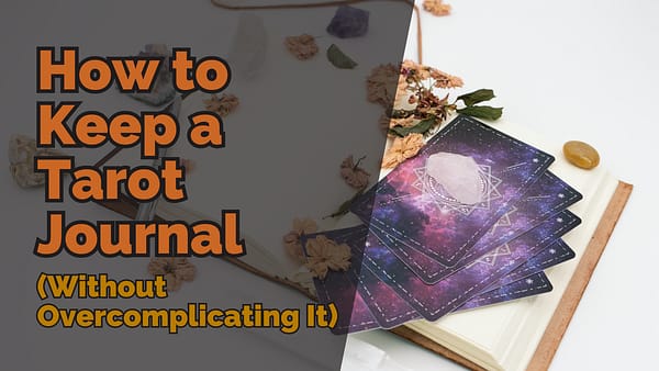 An open tarot journal with a stack of galaxy-themed tarot cards on top, adorned with a clear quartz crystal. Dried flowers and crystals are scattered around. Bold text overlay reads ‘How to Keep a Tarot Journal (Without Overcomplicating It)’.