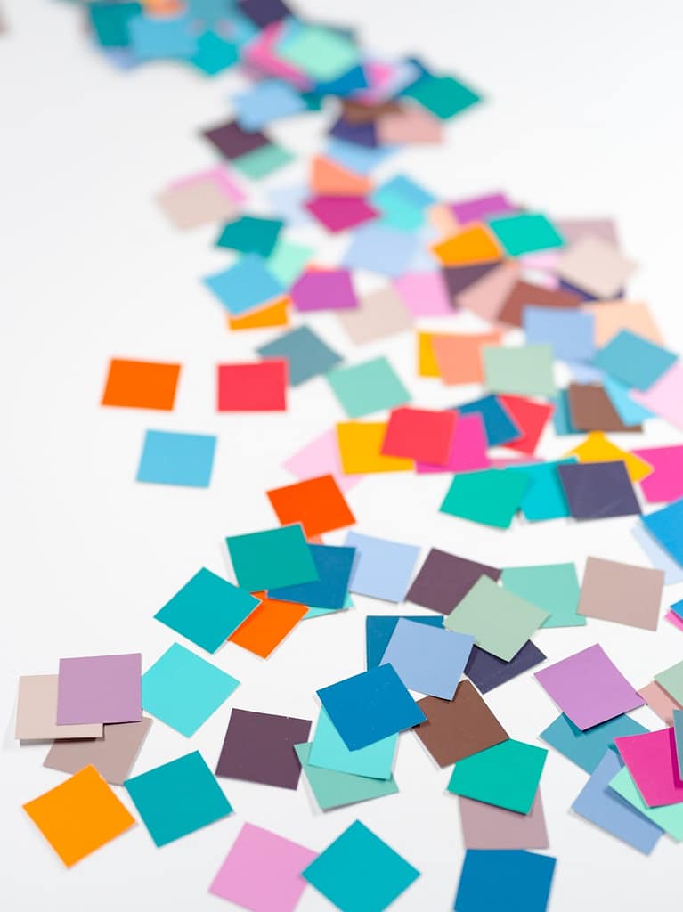 Scattered colourful post-it notes on a white background, symbolising the many unseen elements behind tarot reader pricing and spiritual work