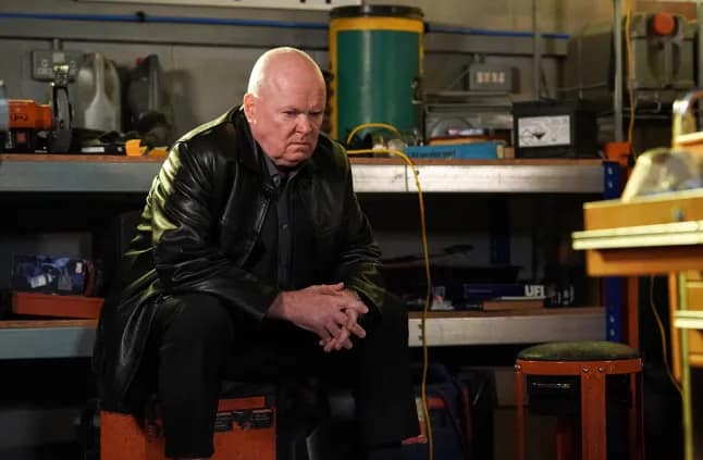 Phil Mitchell sitting in the Arches