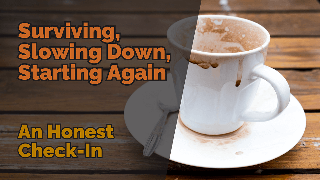 A messy, half-finished cup of hot chocolate or coffee on a white saucer, with smudges and stains around the rim and table. The text ‘surviving, slowing down, starting again: an honest check-in’ is overlaid in bold orange and yellow fonts, set against a wooden background, symbolising pause and reflection.