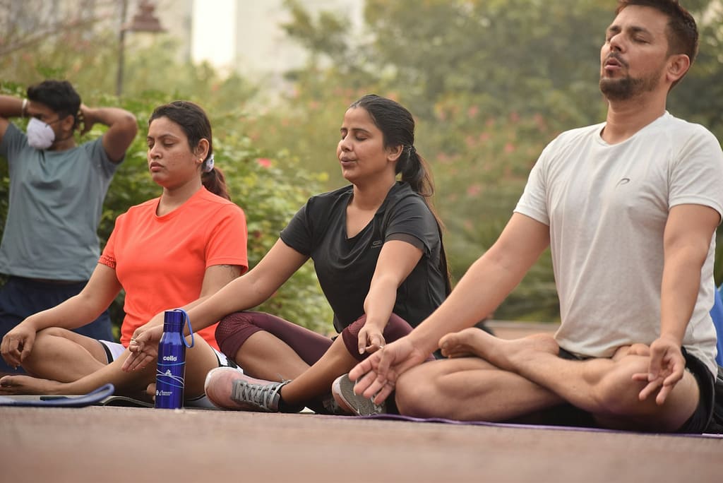 5 Surprising Benefits of Meditation 4 man in black crew neck t-shirt sitting beside man in red crew neck t-shirt