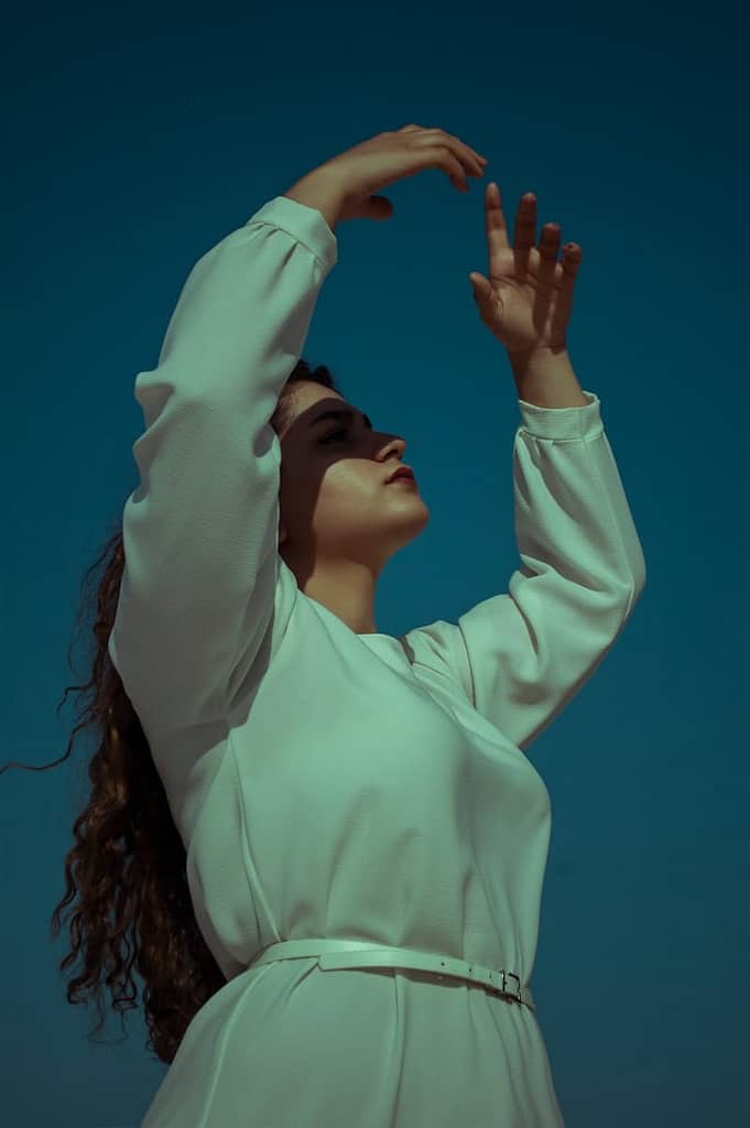 12 Types Of Meditation (That Aren'T Just Sitting Still) 5 Woman in white long sleeve shirt covering her face with her hands