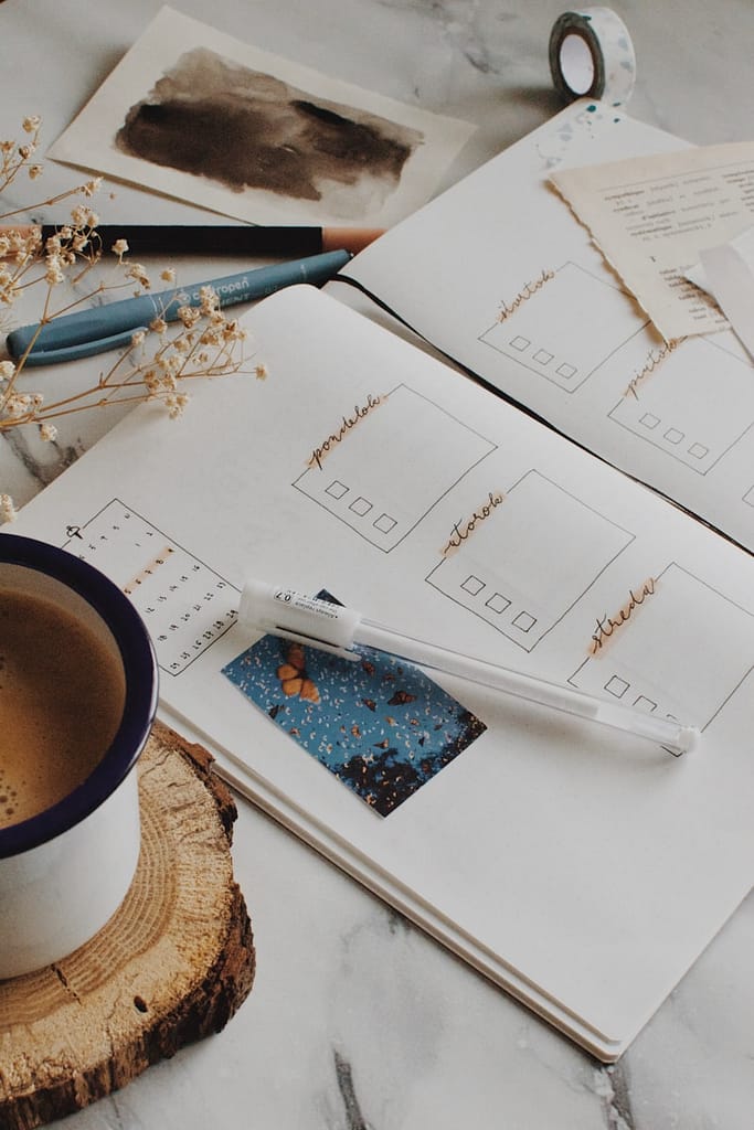 Full Moon in Sagittarius 2 white ceramic mug on white paper journal