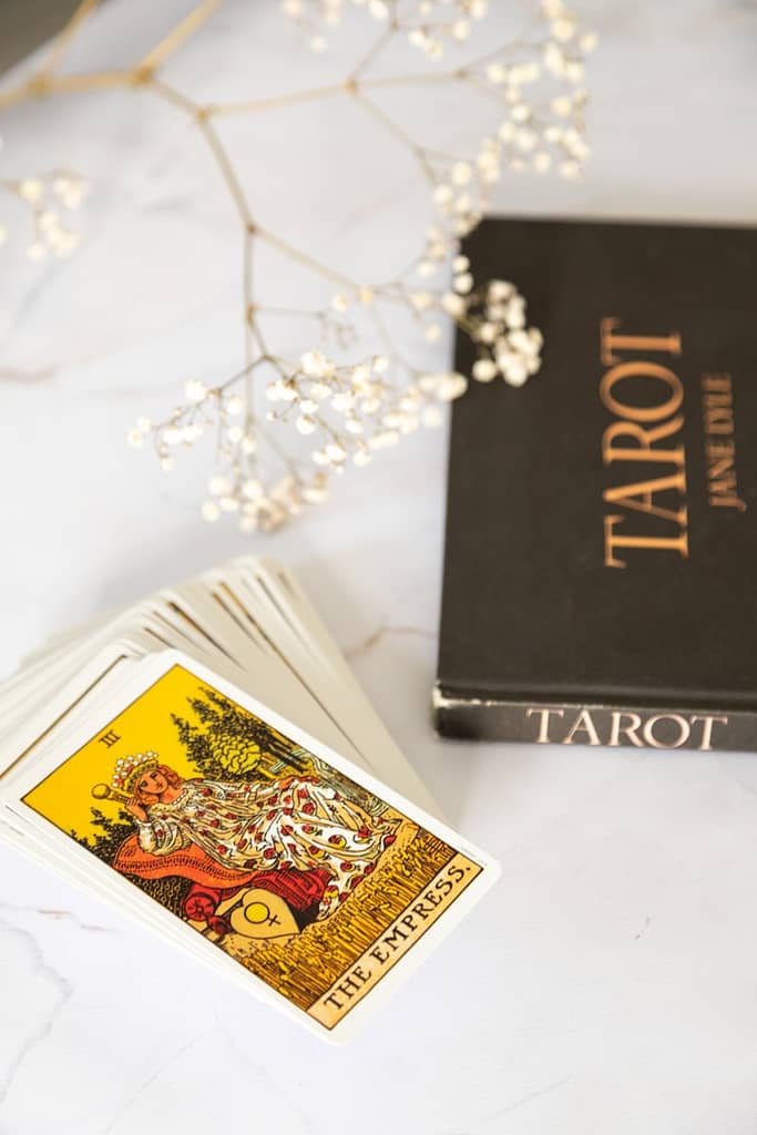 Learn Tarot In Manchester With Simply Tarot Black and gold book on white table