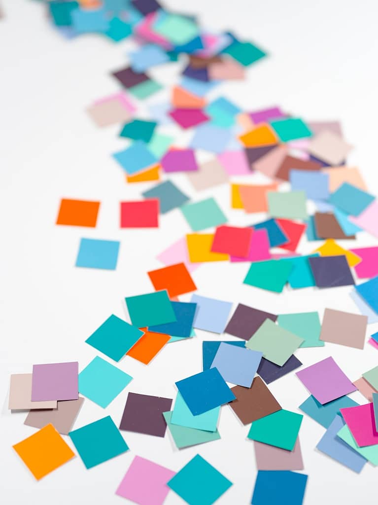 Scattered colourful post-it notes on a white background, symbolising the many unseen elements behind tarot reader pricing and spiritual work