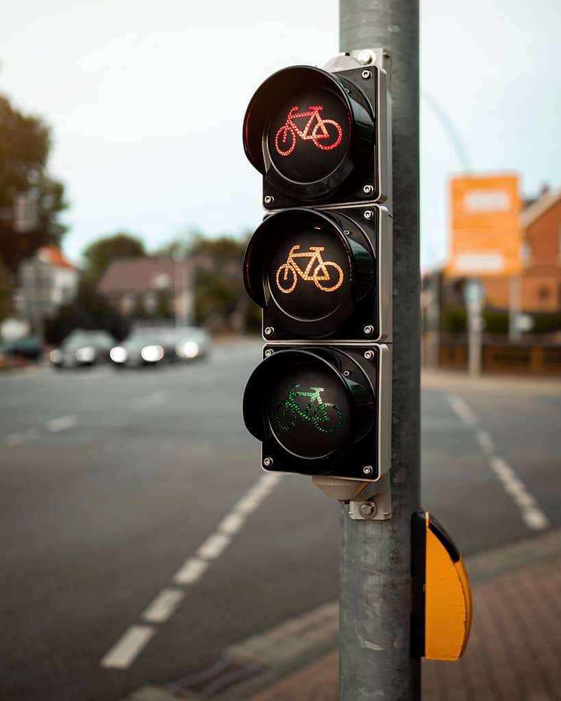 Traffic lights for cyclists showing red, amber, and green signals all at once, symbolising conflicting signals and decision points in a journey.