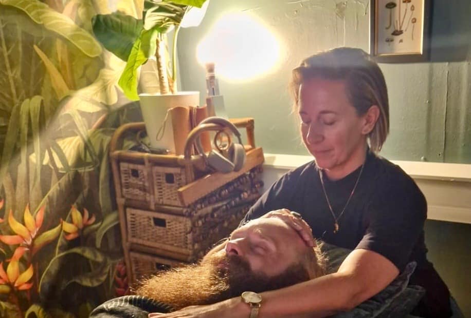 The author of this post receiving some reiki, wondering to themself, is reiki a massage?