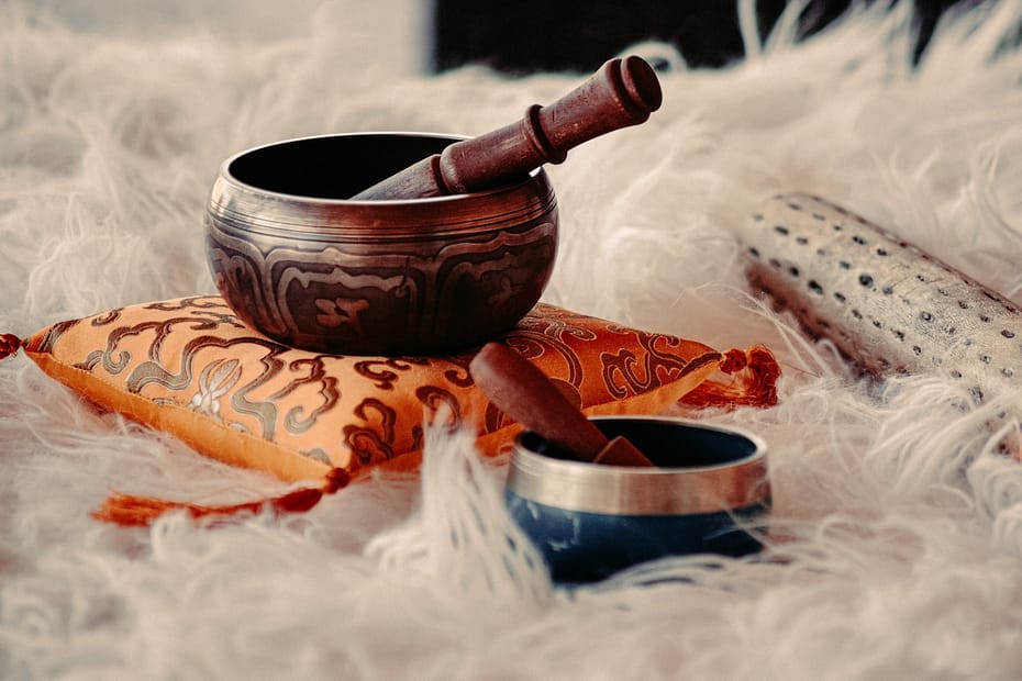 brown wooden mortar and pestle on white textile, what are the benefits of a sound bath