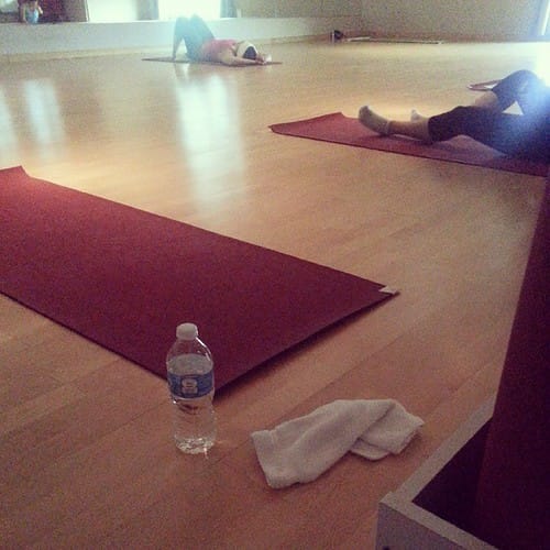 10 Types of Yoga Explained and How to Choose the Right One 6 Yoga studio with red mats and students resting during one of the more restorative types of yoga classes.